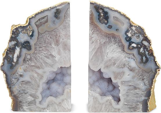 Photograph courtesy Mitchell Gold and Bob Williams

Agate is formed from volcanic rock containing
sparkling crystals and minerals. One piece of agate
is sliced in two to create a pair of bookends.

Their rough exterior contrasts with the rich, highly
polished interior of intricate bands of color and
stunning geological details.

mgbwhome.com
